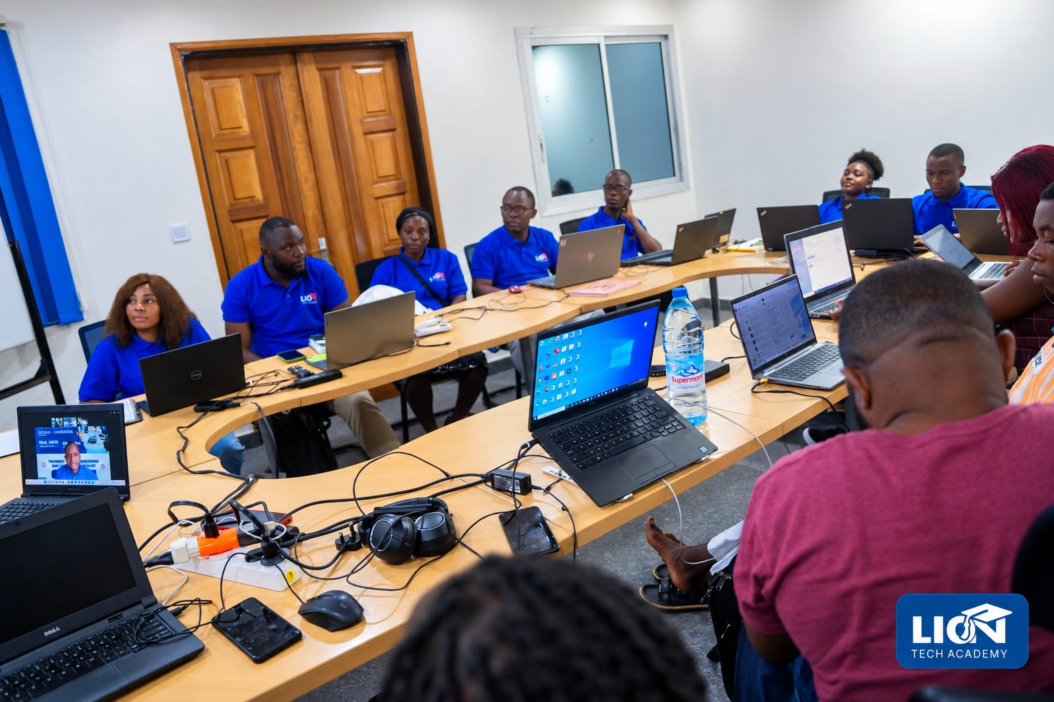 LionTech Academy students working with laptops during practical technology training